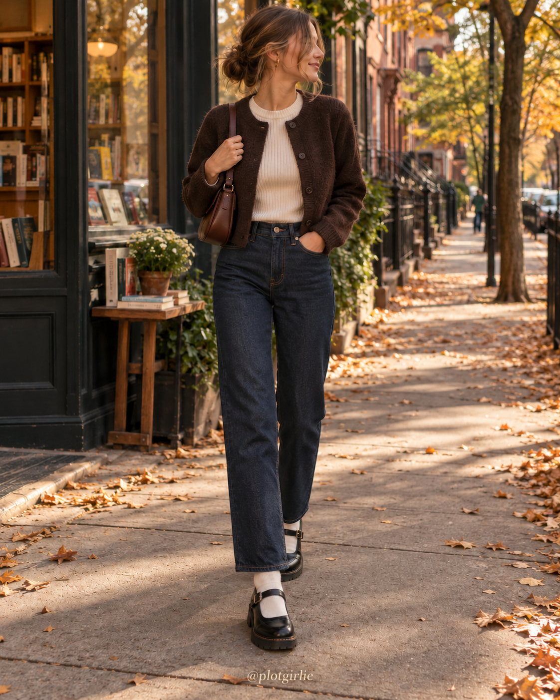 Dark straight jeans, cream knit and black Mary Jane shoes outside a bookshop