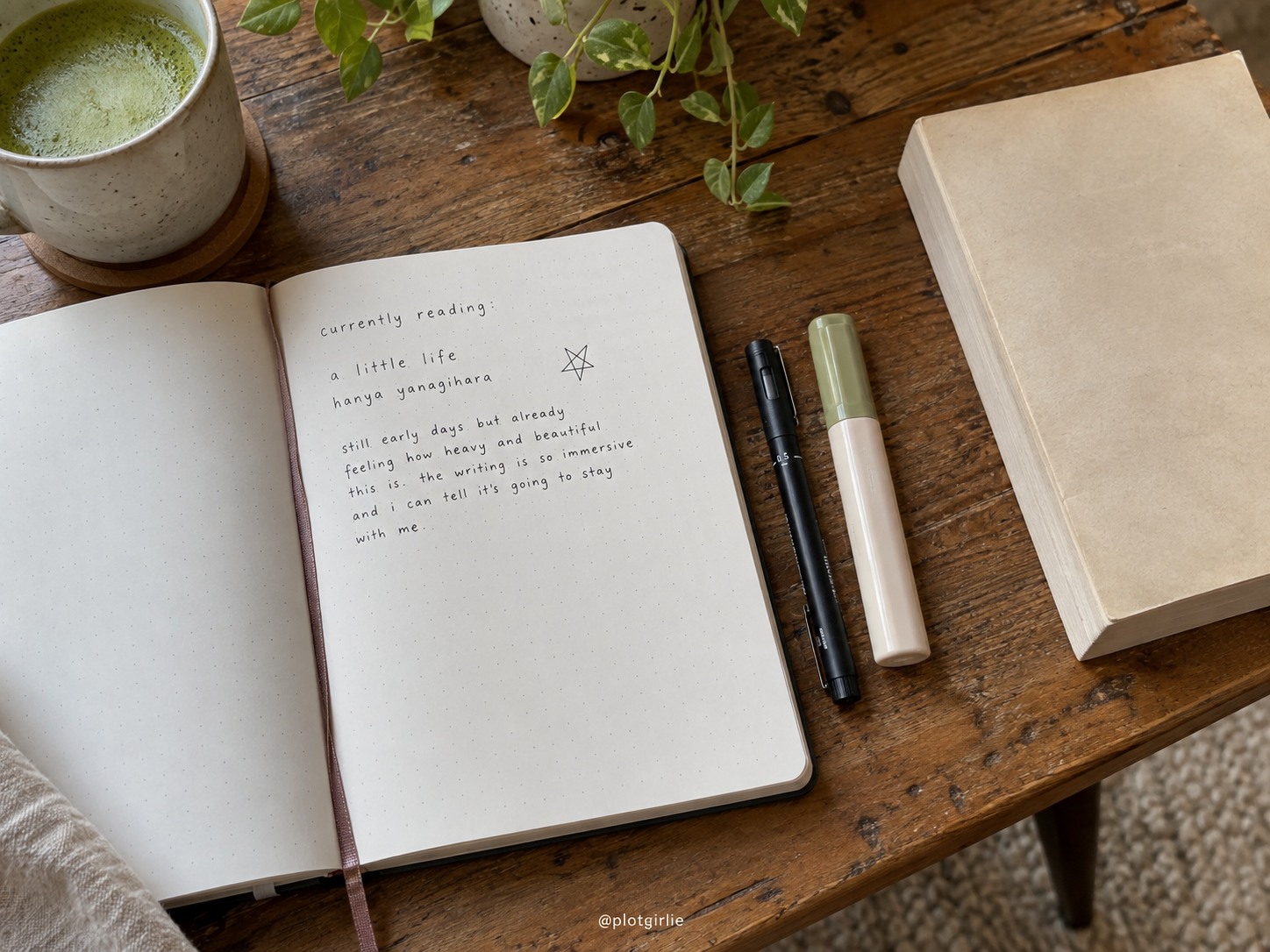 A reading journal with brief handwritten notes, a fineliner and neutral highlighter