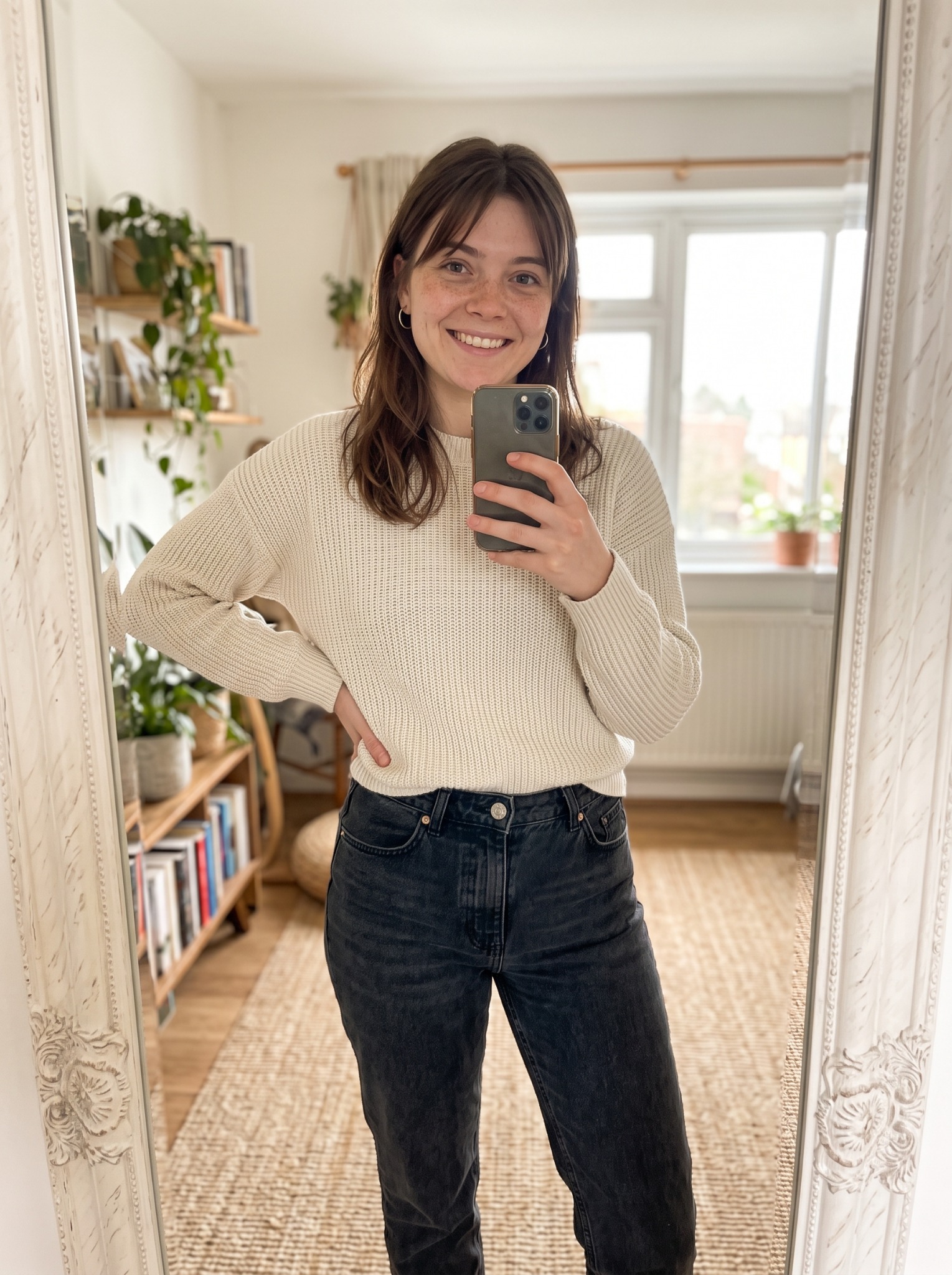 Plotgirlie taking a mirror selfie at home in a cream knit sweater